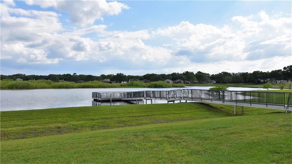 1652 Cherry Ridge Drive Lake Mary, FL 32746 - Photo 59 of 62 a view of a lake with houses in the back