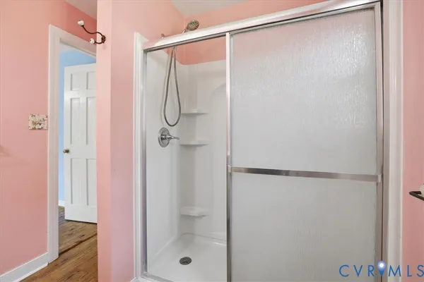 a bathroom with a glass shower door