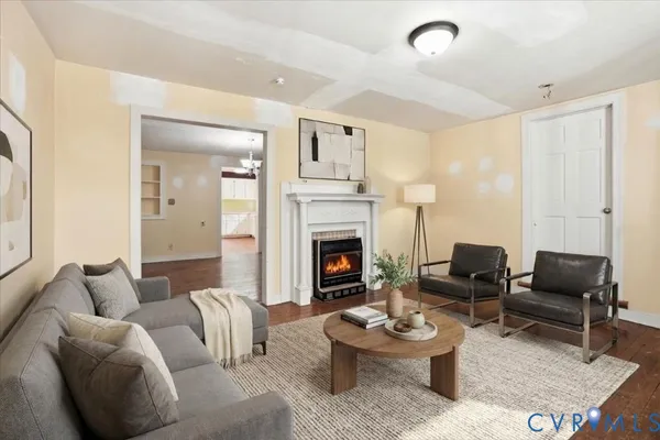 a living room with furniture a fireplace and a large window