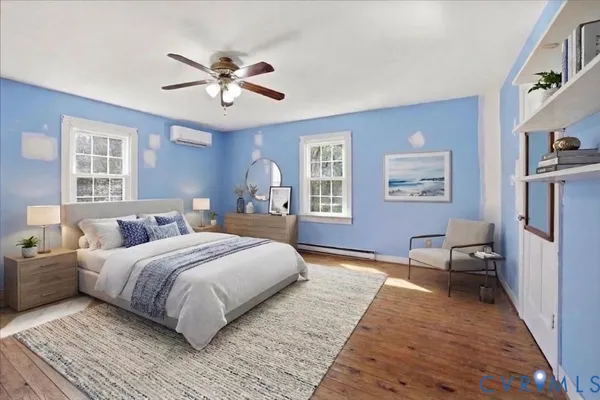 a spacious bedroom with a large bed and a chandelier