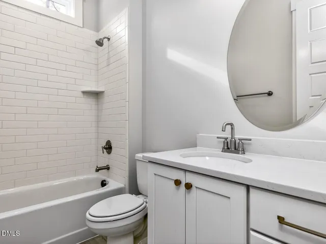 a bathroom with a bathtub and a toilet