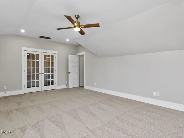 a view of balcony with floor to ceiling window next to a yard