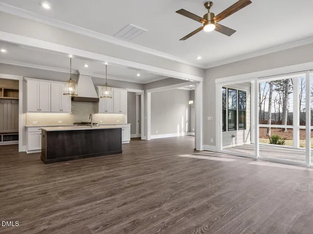 a view of kitchen and kitchen with granite countertop wooden floor