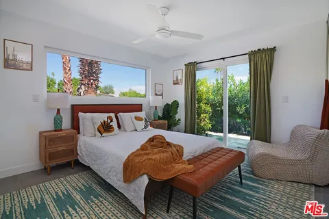 a bedroom with a bed and a couch