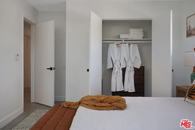 a bedroom with a bed and a closet