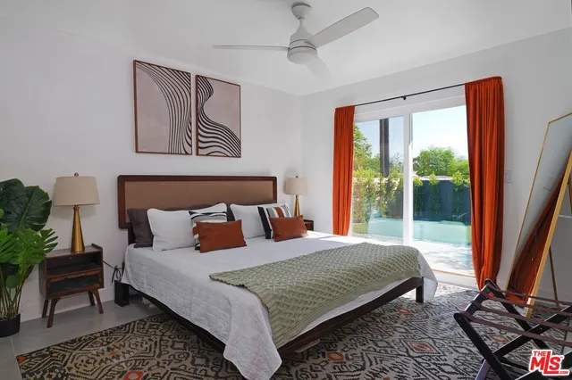 a bedroom with a large bed and a window