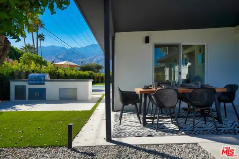 a view of a house with backyard porch and sitting area