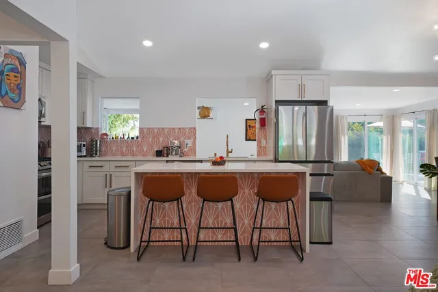 a living room with furniture and a kitchen
