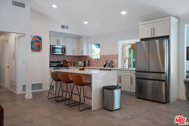 a kitchen with refrigerator and table