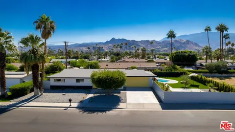 a view of a house with a yard and sitting area