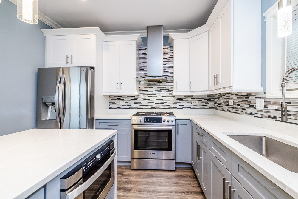 1300 South Heath Avenue Chicago, IL 60608 - Photo 13 of 55 a kitchen with stainless steel appliances a stove sink and cabinets