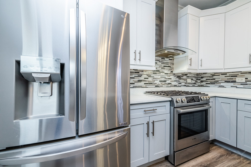 1300 South Heath Avenue Chicago, IL 60608 - Photo 14 of 55 a kitchen with stainless steel appliances granite countertop a refrigerator sink and stove