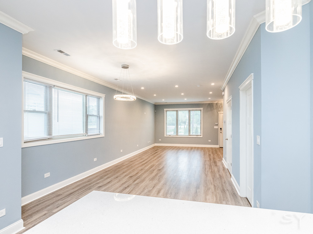 1300 South Heath Avenue Chicago, IL 60608 - Photo 18 of 55 a view of an empty room with wooden floor and a window