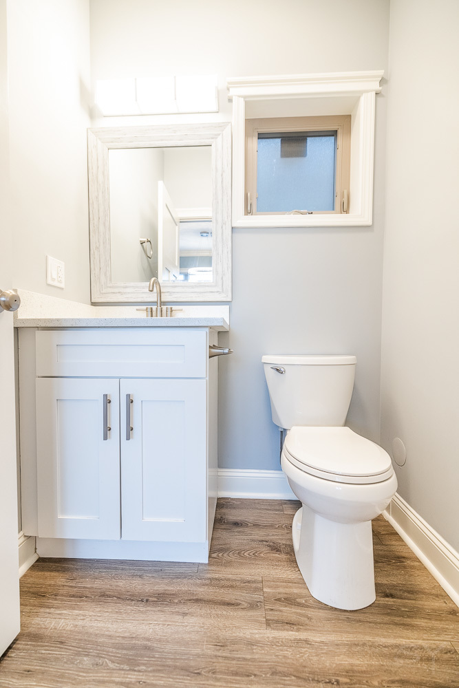 1300 South Heath Avenue Chicago, IL 60608 - Photo 21 of 55 a bathroom with a toilet a sink and mirror