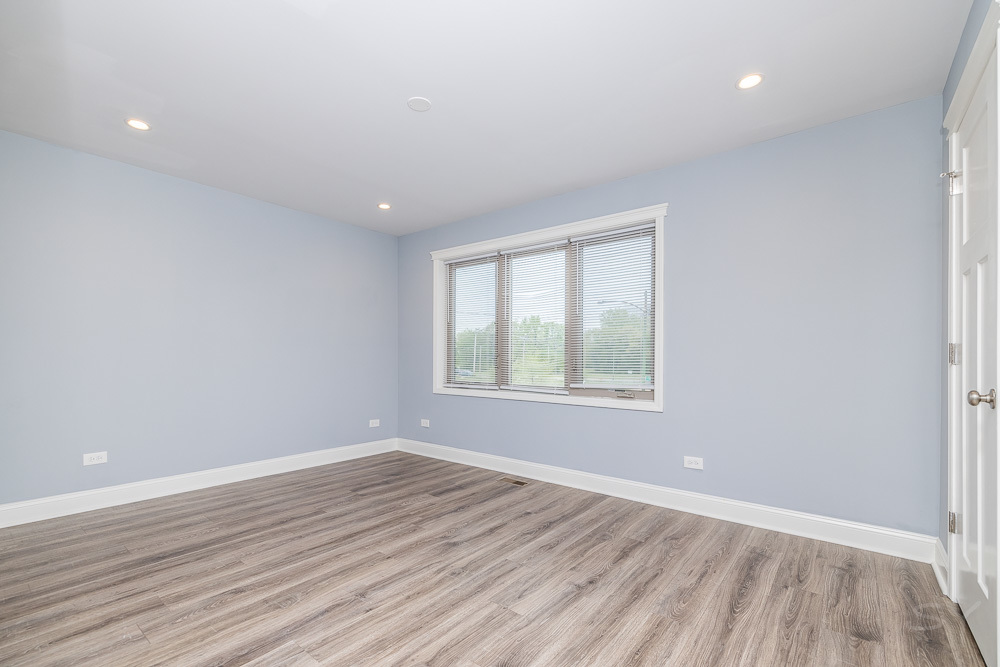 1300 South Heath Avenue Chicago, IL 60608 - Photo 29 of 55 wooden floor in an empty room with a window