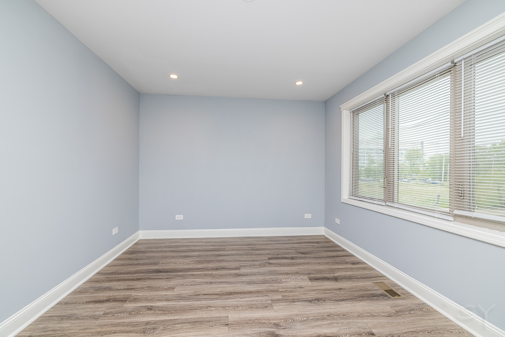 1300 South Heath Avenue Chicago, IL 60608 - Photo 30 of 55 a view of empty room with wooden floor and fan