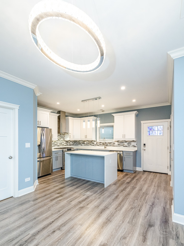 1300 South Heath Avenue Chicago, IL 60608 - Photo 3 of 55 a large kitchen with granite countertop a stove top oven a refrigerator a sink dishwasher with a dining table and chairs