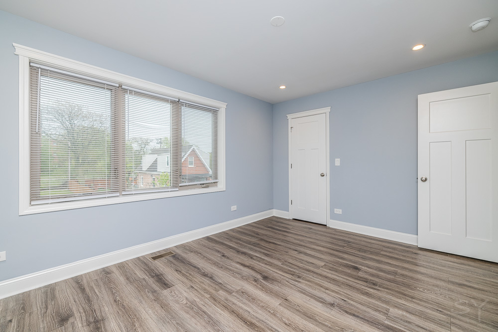 1300 South Heath Avenue Chicago, IL 60608 - Photo 31 of 55 a view of an empty room with wooden floor and a window