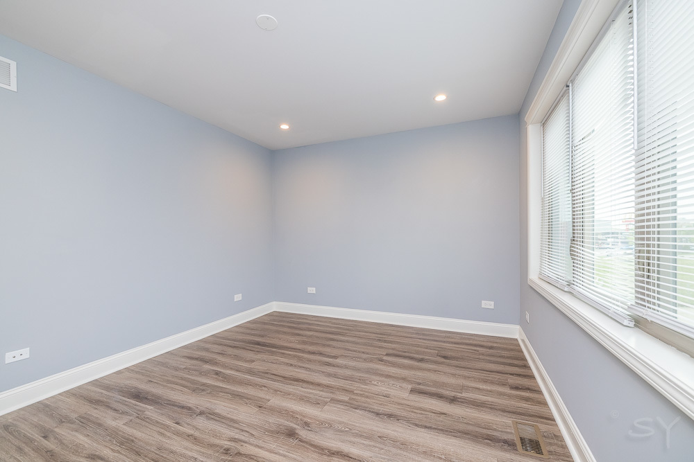 1300 South Heath Avenue Chicago, IL 60608 - Photo 33 of 55 wooden floor in an empty room with a window