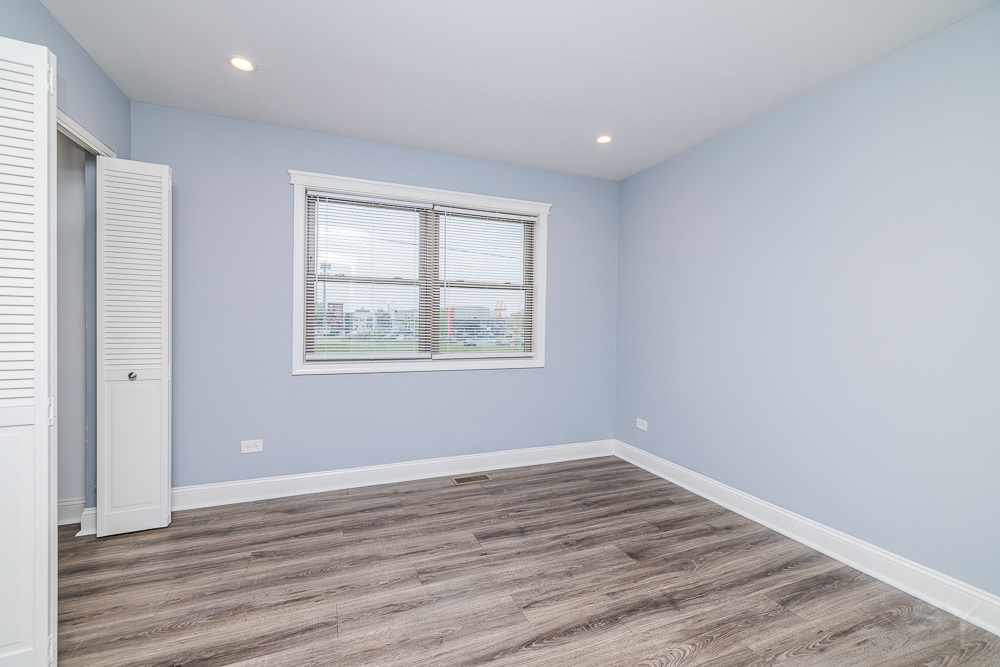 1300 South Heath Avenue Chicago, IL 60608 - Photo 34 of 55 wooden floor in an empty room with a window