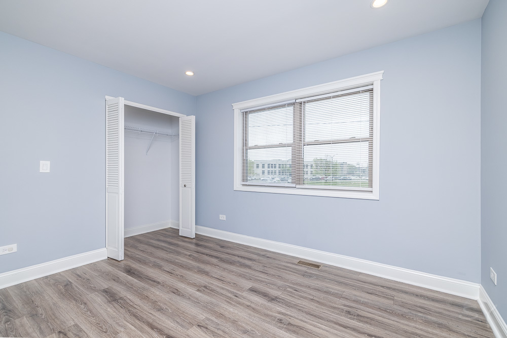 1300 South Heath Avenue Chicago, IL 60608 - Photo 35 of 55 a view of an empty room with wooden floor and a window