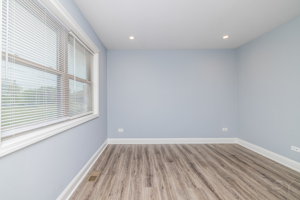 1300 South Heath Avenue Chicago, IL 60608 - Photo 36 of 55 a view of an empty room with wooden floor and a window