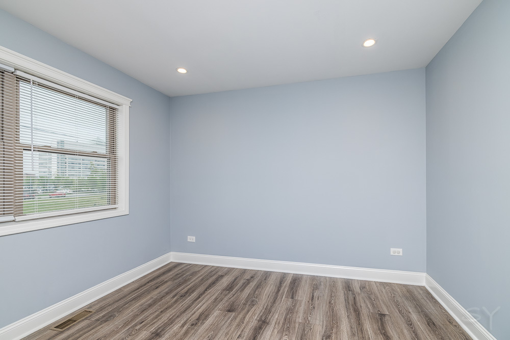 1300 South Heath Avenue Chicago, IL 60608 - Photo 37 of 55 an empty room with wooden floor and windows