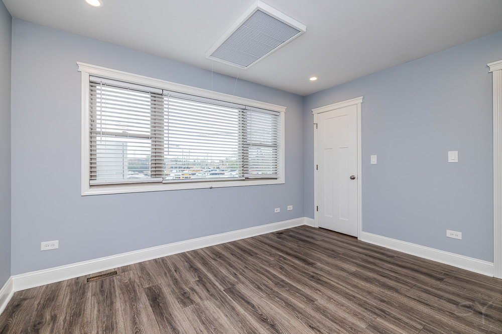 1300 South Heath Avenue Chicago, IL 60608 - Photo 45 of 55 a view of an empty room with wooden floor and a window