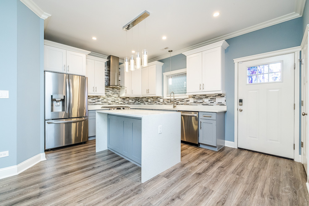1300 South Heath Avenue Chicago, IL 60608 - Photo 5 of 55 a kitchen with stainless steel appliances a refrigerator a sink dishwasher a stove and white cabinets with wooden floor