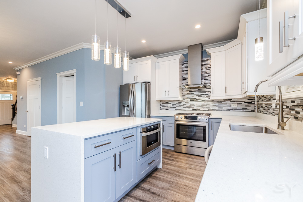 1300 South Heath Avenue Chicago, IL 60608 - Photo 10 of 55 a kitchen with white cabinets and stainless steel appliances