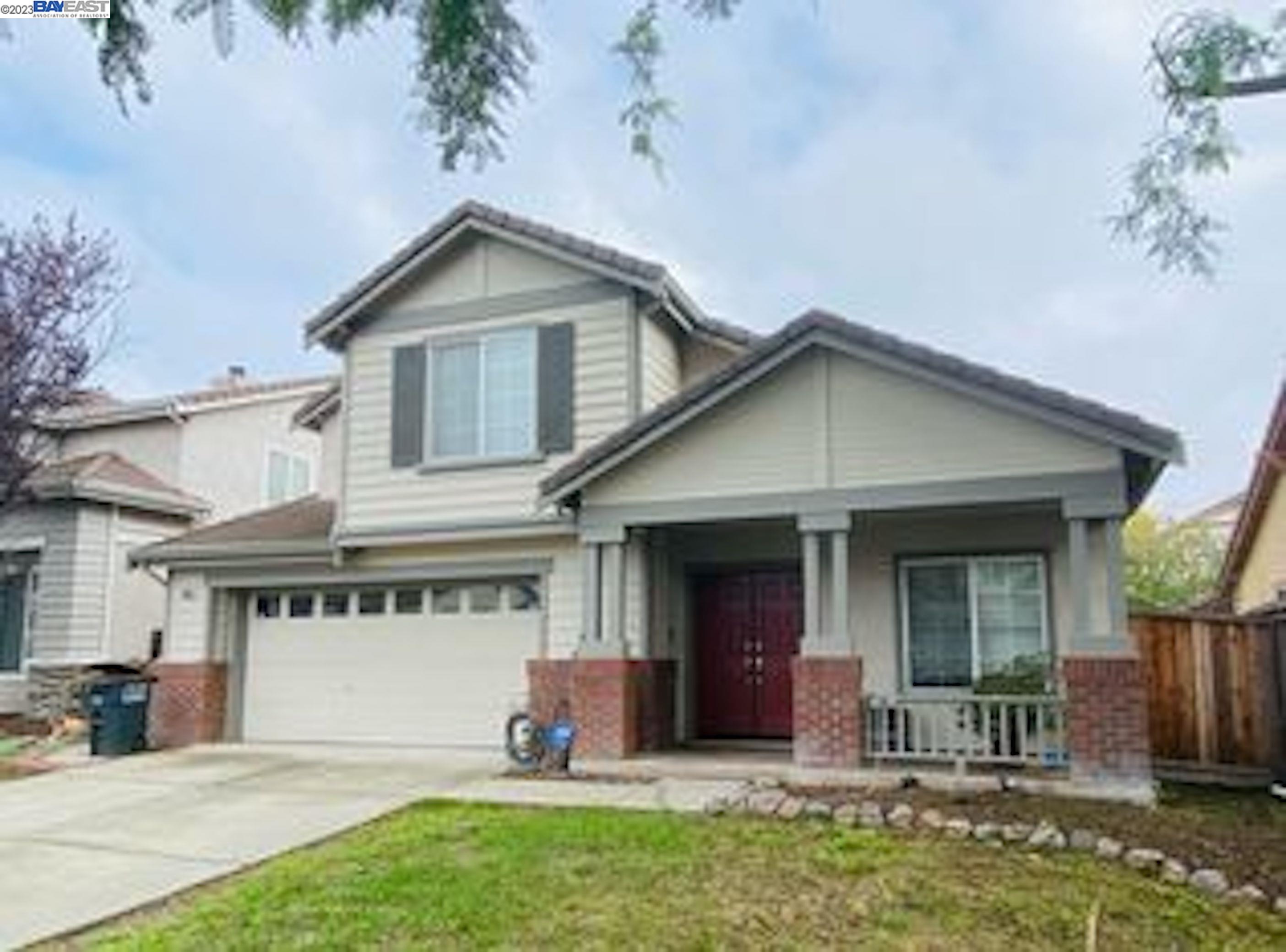 a view of a house with table and chairs in patio