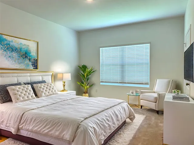 a bedroom with a large bed and a window