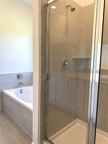a bathroom with a bathtub and shower