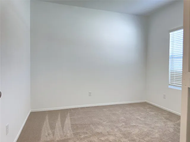 a view of an empty room and a window