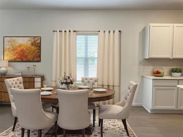 a dining room with furniture and window