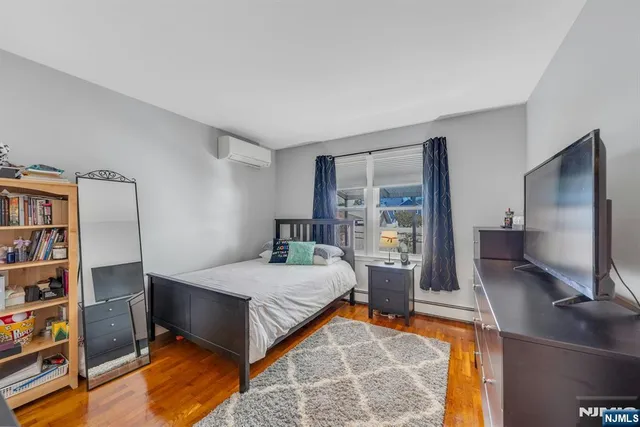 a bedroom with a bed and dresser