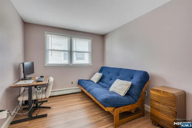a view of a workspace with furniture and a window