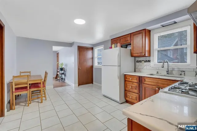 a kitchen with stainless steel appliances granite countertop a refrigerator sink and cabinets