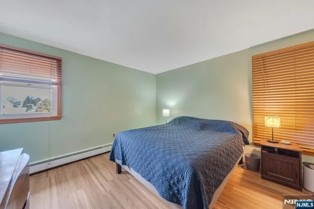 a bed sitting in a bedroom next to a window