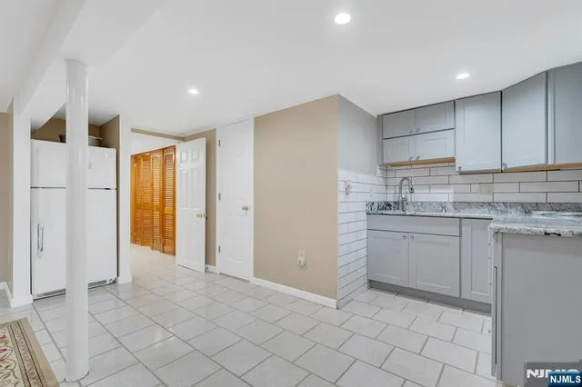 a kitchen with a sink window and cabinets