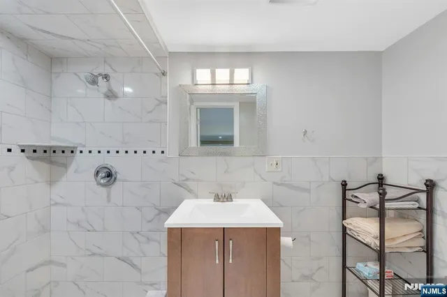 a bathroom with a sink a vanity and mirror