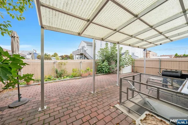 a view of a patio with table and chairs potted plants with wooden fence
