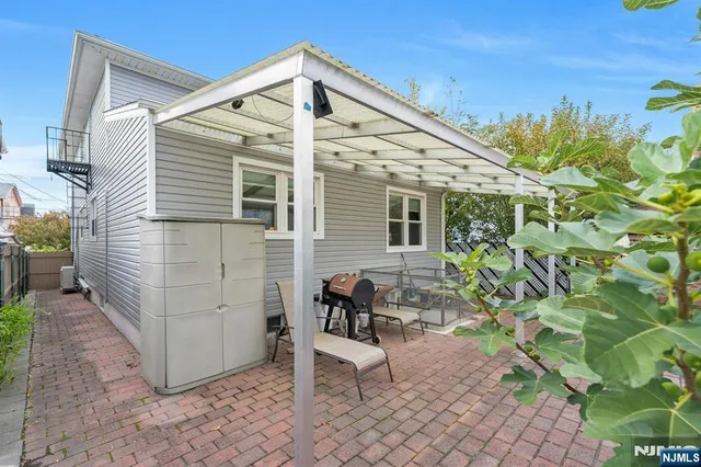 a view of a chair and table in the backyard