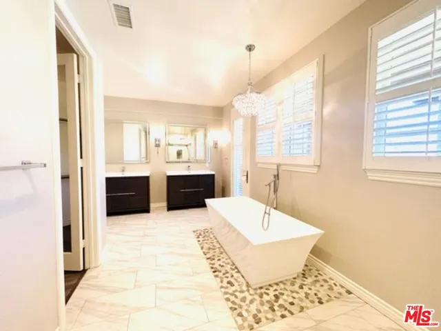a large white kitchen with a large window