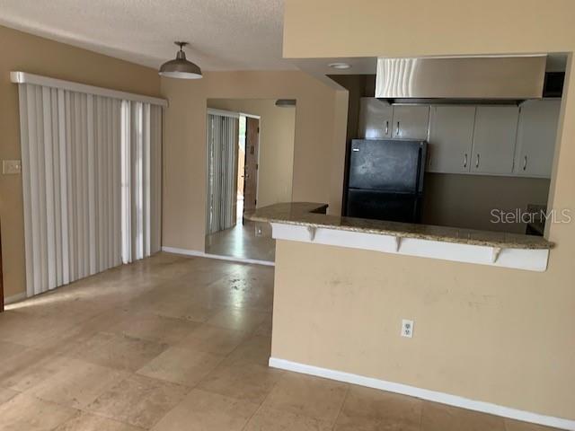 120 America Street, Unit 7 Orlando, FL 32801 - Photo 11 of 13 a kitchen with stainless steel appliances a refrigerator and a microwave