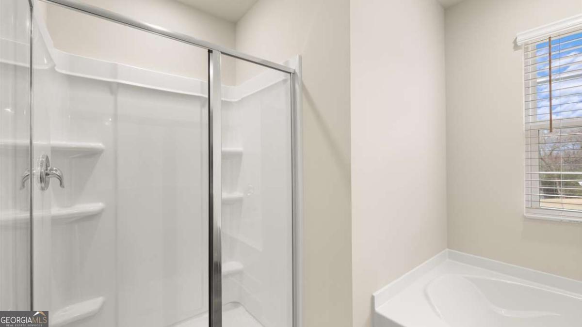 100 Planters Row Perry, GA 31069 - Photo 19 of 37 a bathroom with a bathtub and a shower