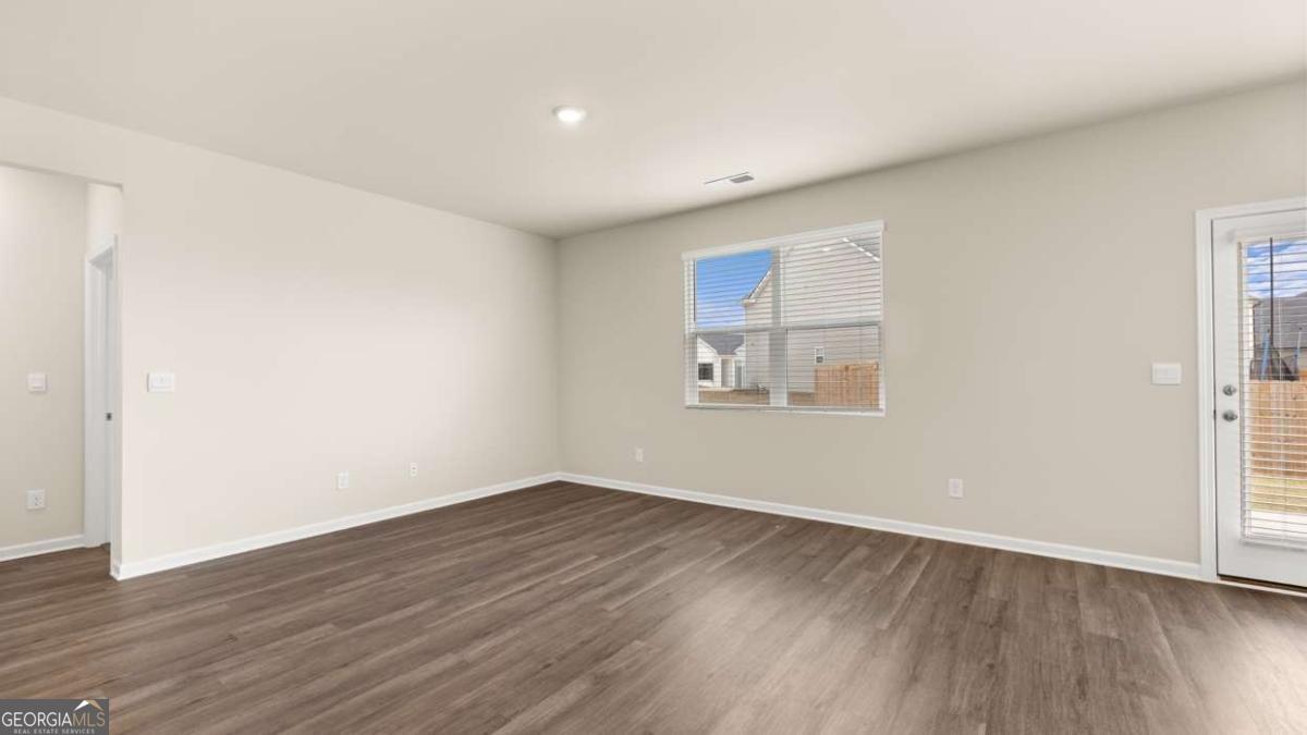 100 Planters Row Perry, GA 31069 - Photo 27 of 37 an empty room with wooden floor and windows