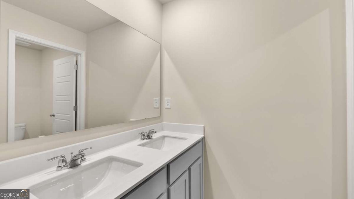 100 Planters Row Perry, GA 31069 - Photo 29 of 37 a bathroom with a sink vanity and a mirror