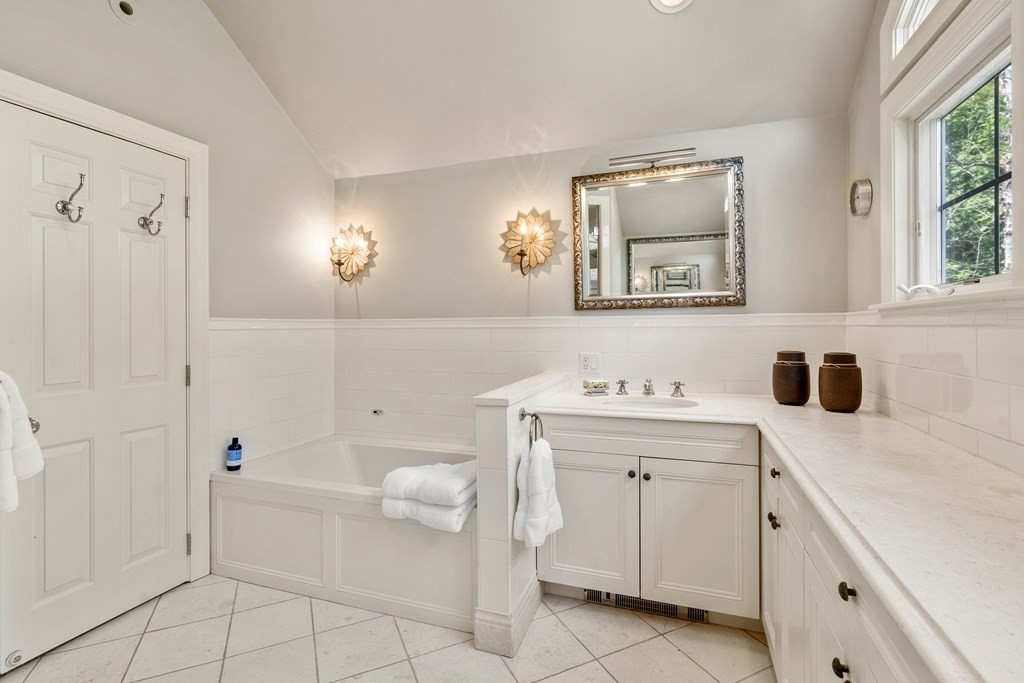 74 Shaw Road Belmont, MA 02478 - Photo 18 of 31 a spacious bathroom with a granite countertop sink and a mirror