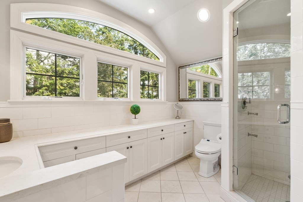 74 Shaw Road Belmont, MA 02478 - Photo 19 of 31 a spacious bathroom with a granite countertop toilet a sink and a large mirror